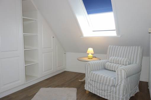 Ankleidezimmer mit großem Sessel.